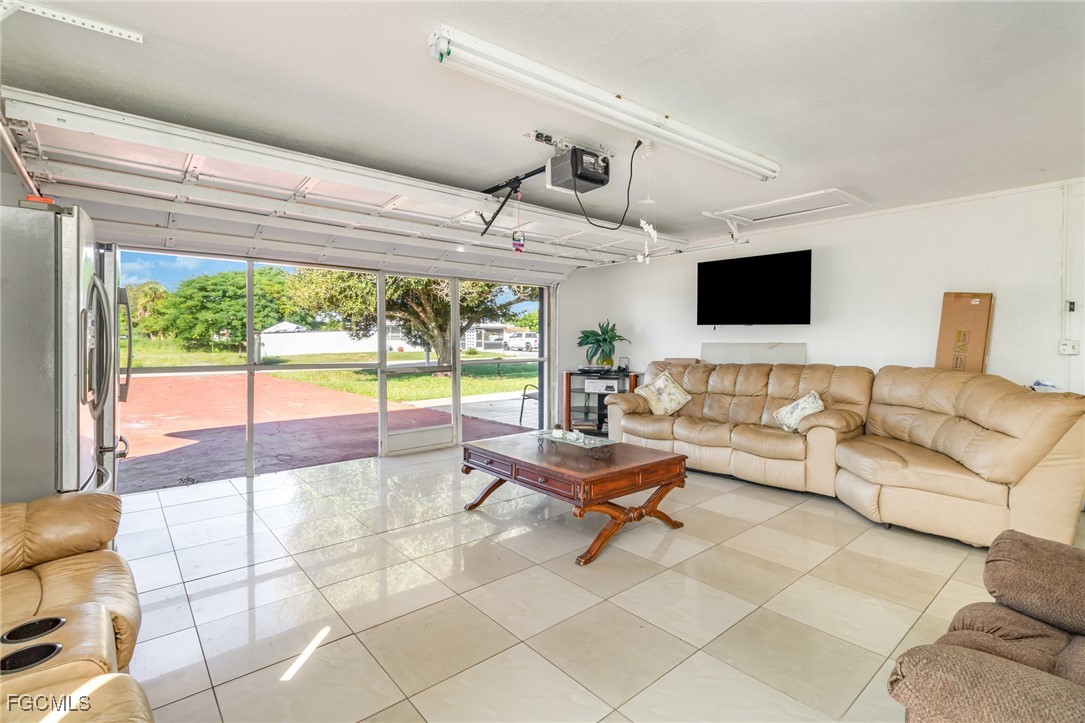 18 Illinois Road Lehigh Acres, FL 33936 - Photo 10 of 28 a living room with furniture and a flat screen tv