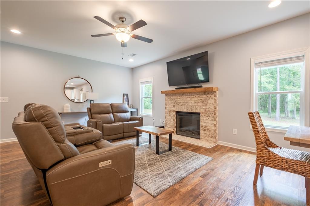719 Fairview Road Brooks, GA 30205 - Photo 4 of 35 a living room with furniture a fireplace and a flat screen tv