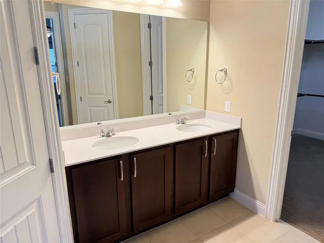 an empty room with chandelier fan