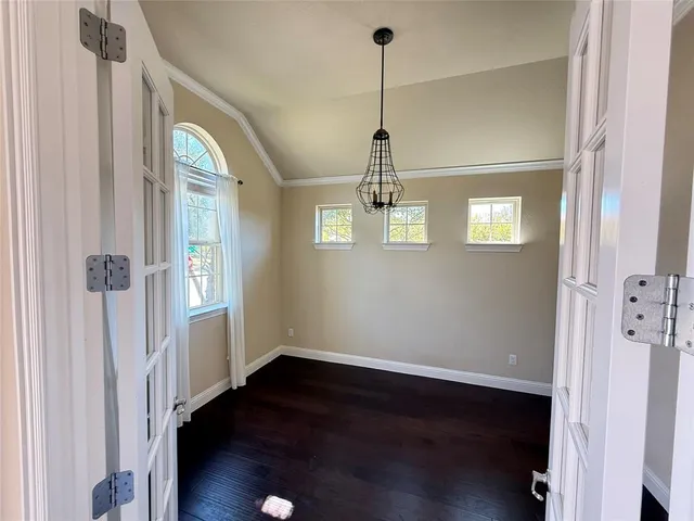 a view of a hallway with wooden floor and stairs