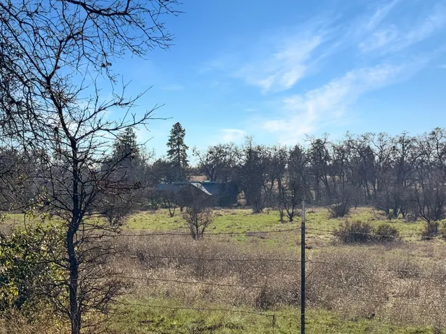 a view of a lake with houses in back
