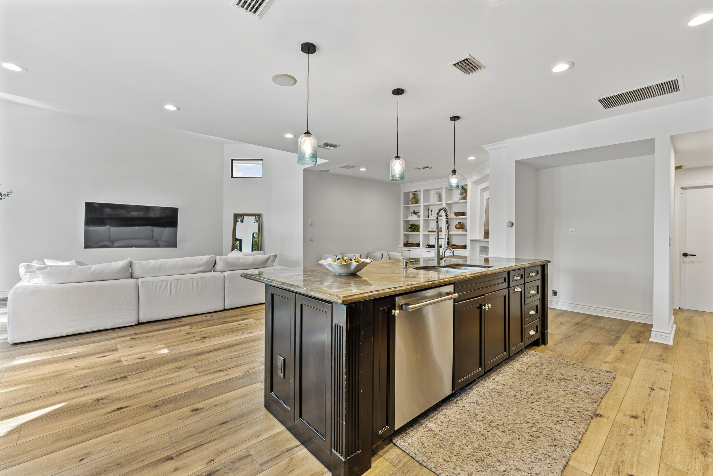 1925 Parkside Circle South Boca Raton, FL 33486 - Photo 22 of 61 a large kitchen with stainless steel appliances kitchen island granite countertop a sink and a wooden floor