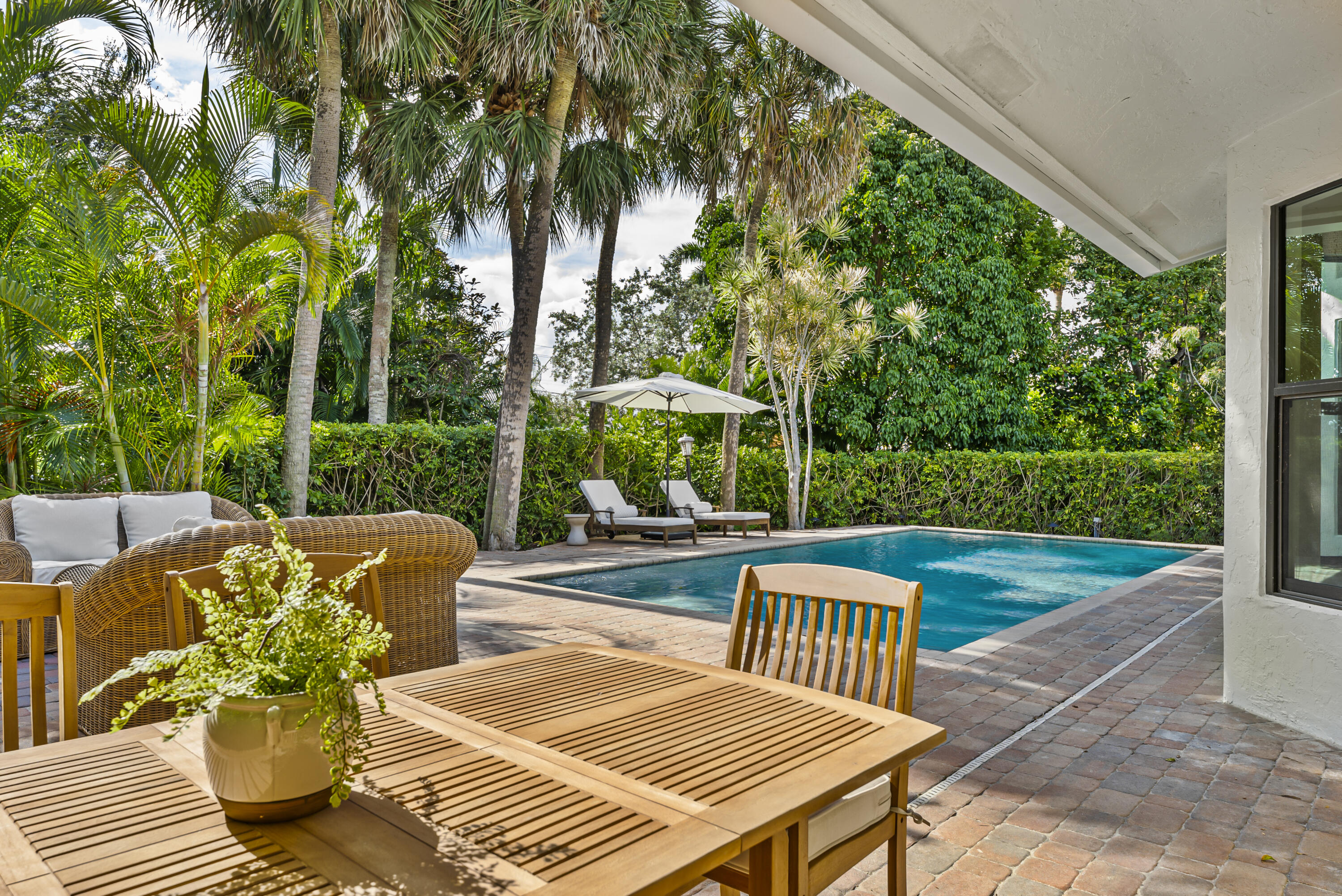 1925 Parkside Circle South Boca Raton, FL 33486 - Photo 45 of 61 a view of a patio with couches table and chairs and potted plants