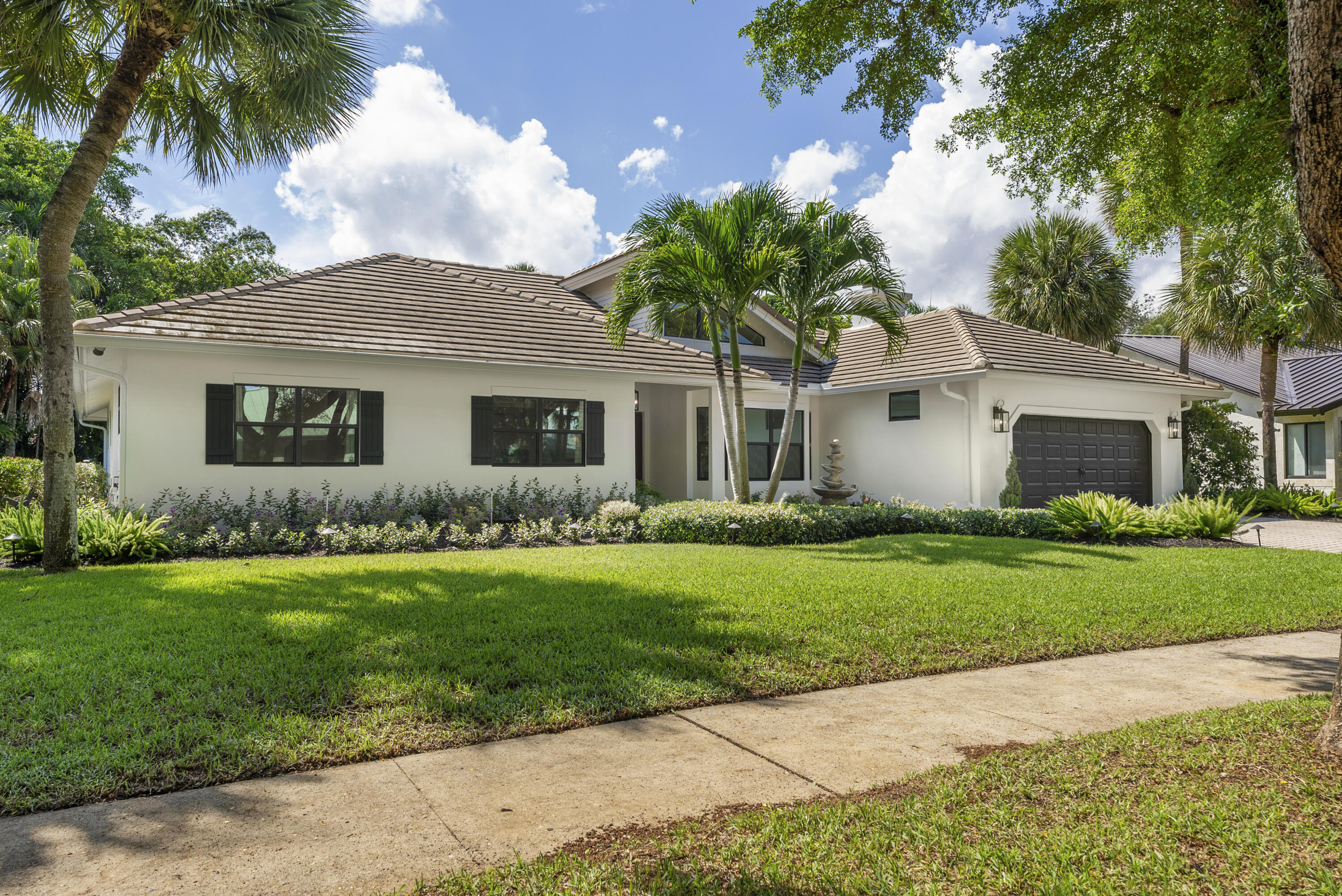 1925 Parkside Circle South Boca Raton, FL 33486 - Photo 55 of 61 a front view of a house with a garden