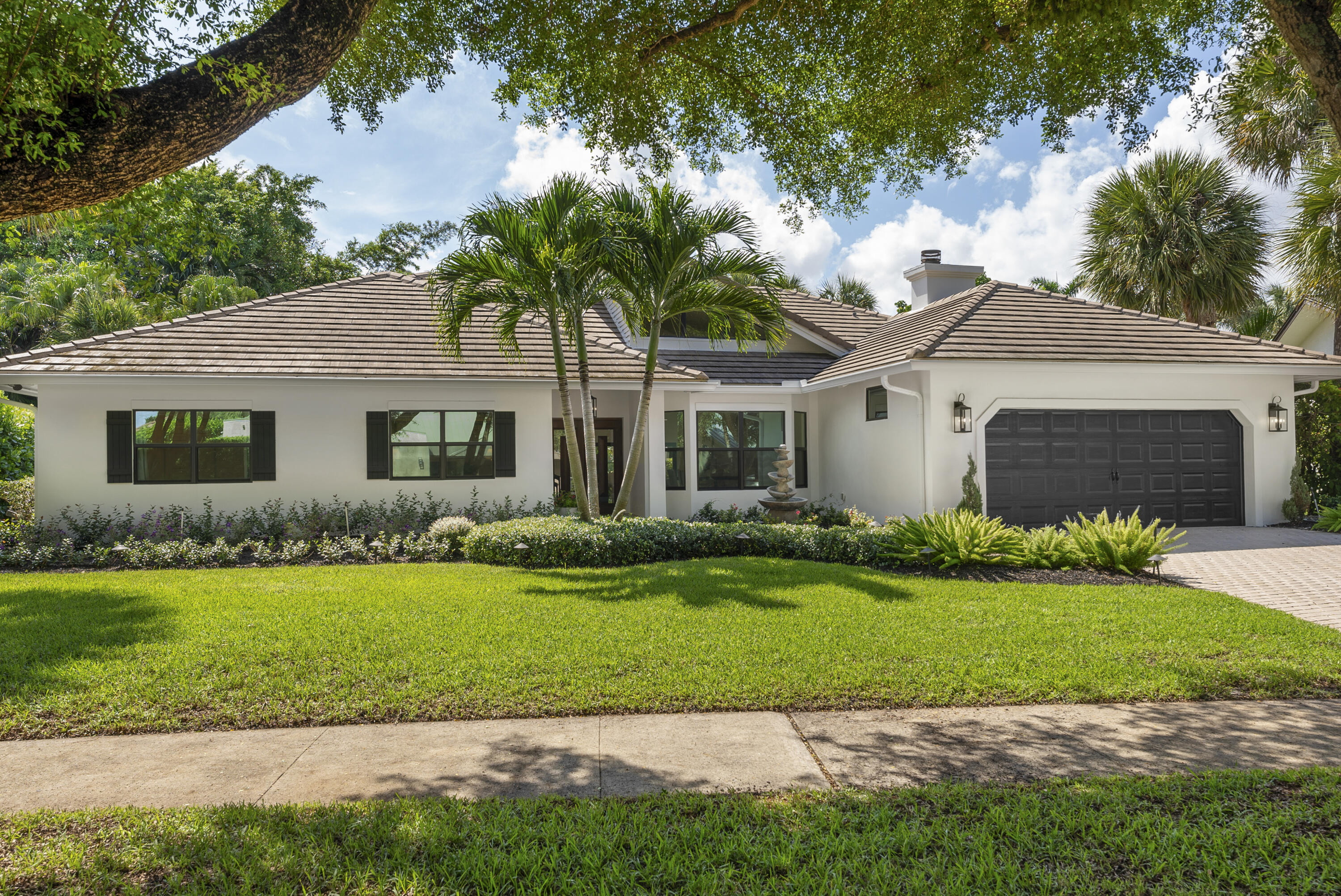 1925 Parkside Circle South Boca Raton, FL 33486 - Photo 56 of 61 a front view of a house with a garden and yard