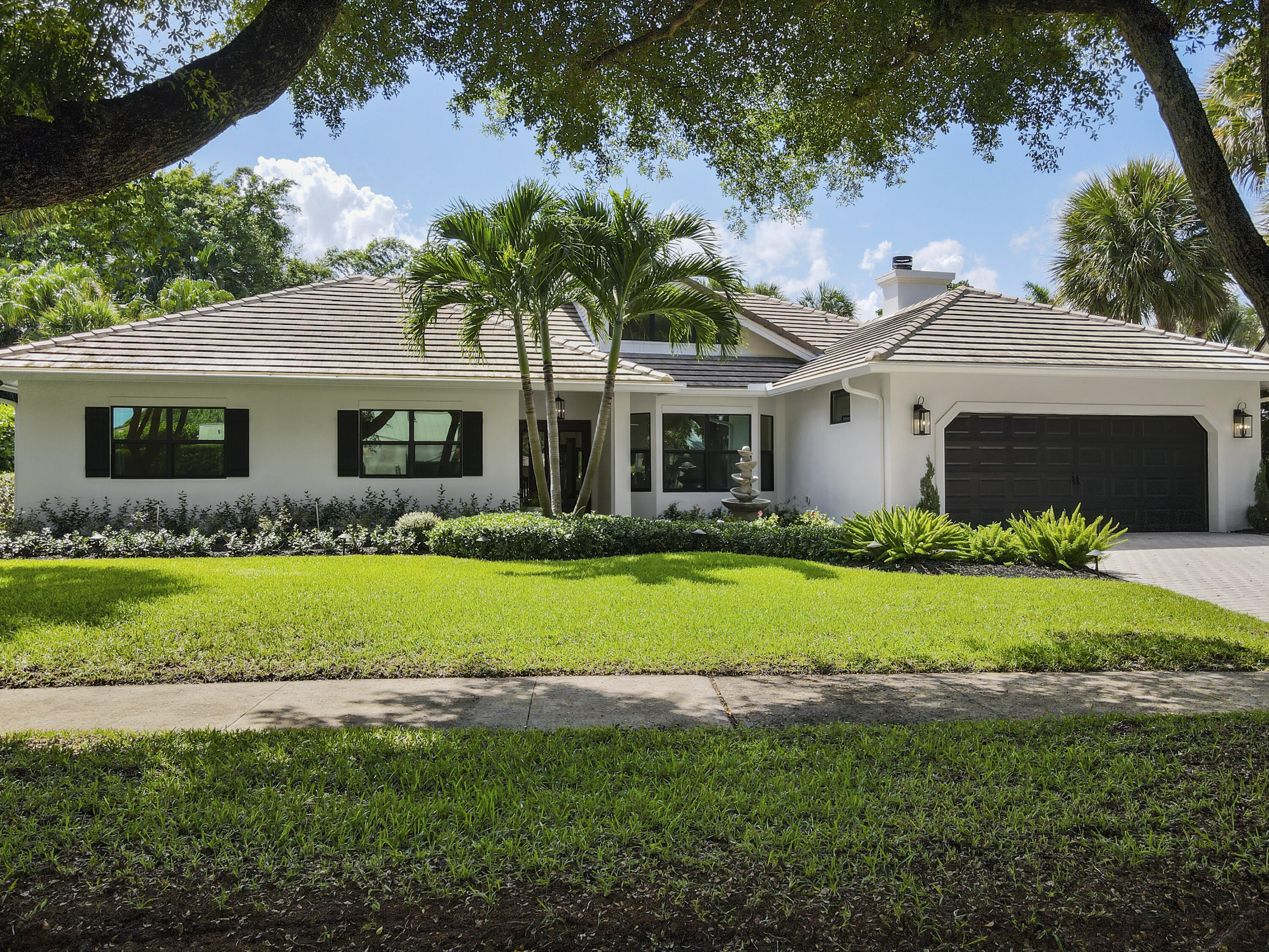 1925 Parkside Circle South Boca Raton, FL 33486 - Photo 60 of 61 a front view of a house with a yard and potted plants