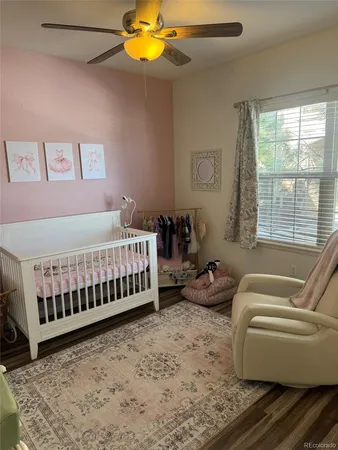 a bedroom with a bed wooden floor and window