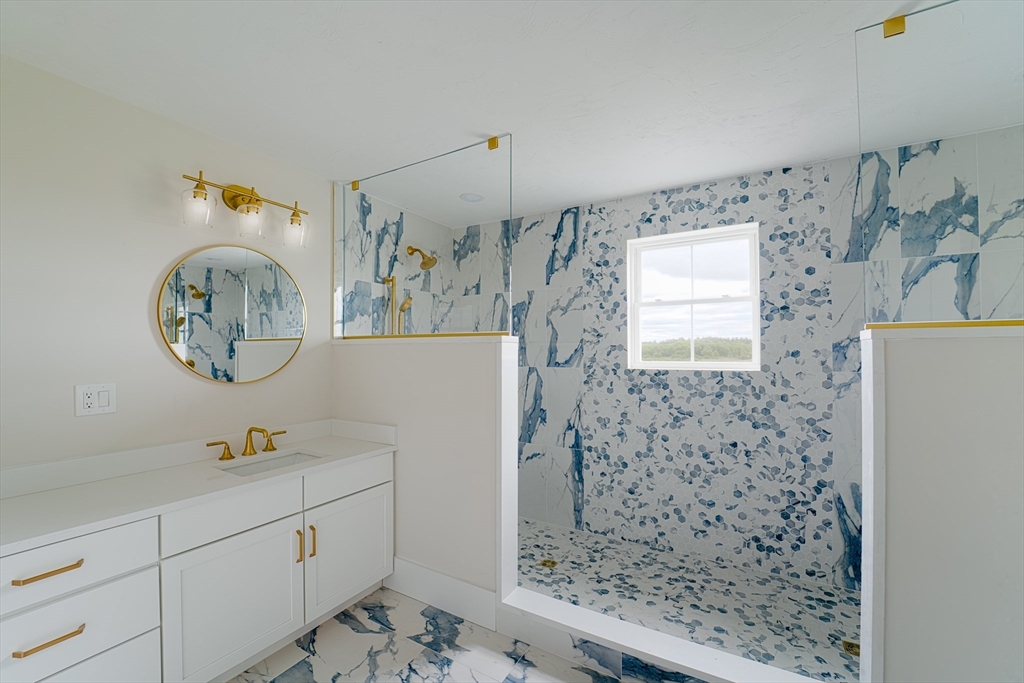 20 Metacomet Road, Unit 20 West Bridgewater, MA 02379 - Photo 21 of 30 a bathroom with a sink a mirror and shower