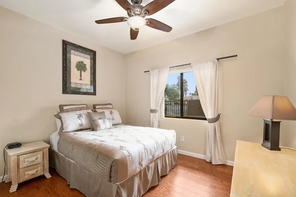 a bedroom with a bed and a large mirror