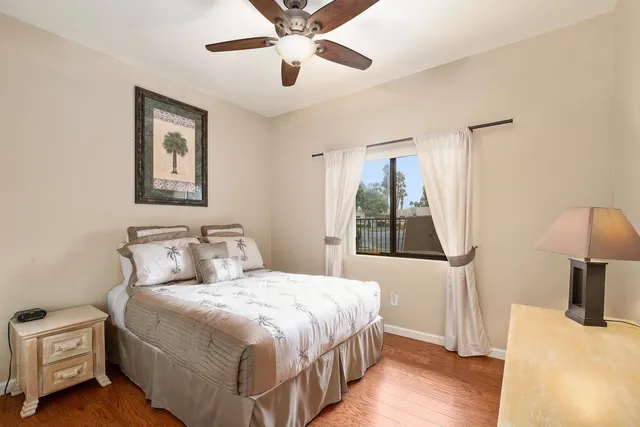 a bedroom with a bed and a large mirror