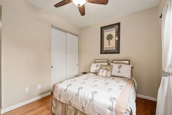 a bedroom with a bed and a painting on the wall