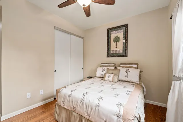 a bedroom with a bed and a painting on the wall