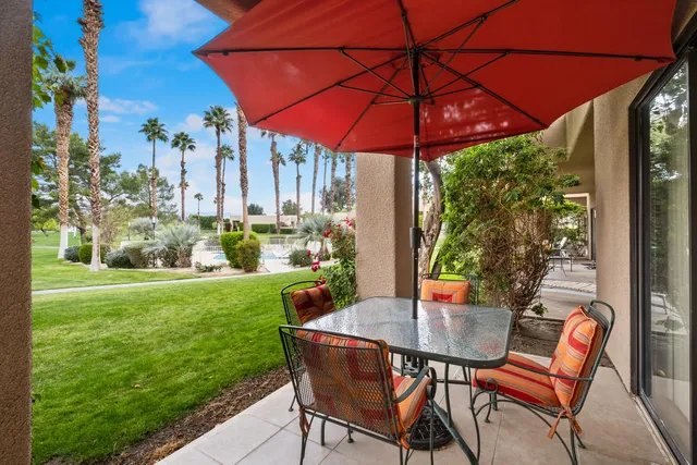 a view of an outdoor sitting area with furniture and backyard
