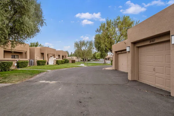 a view of a house with a yard and garage