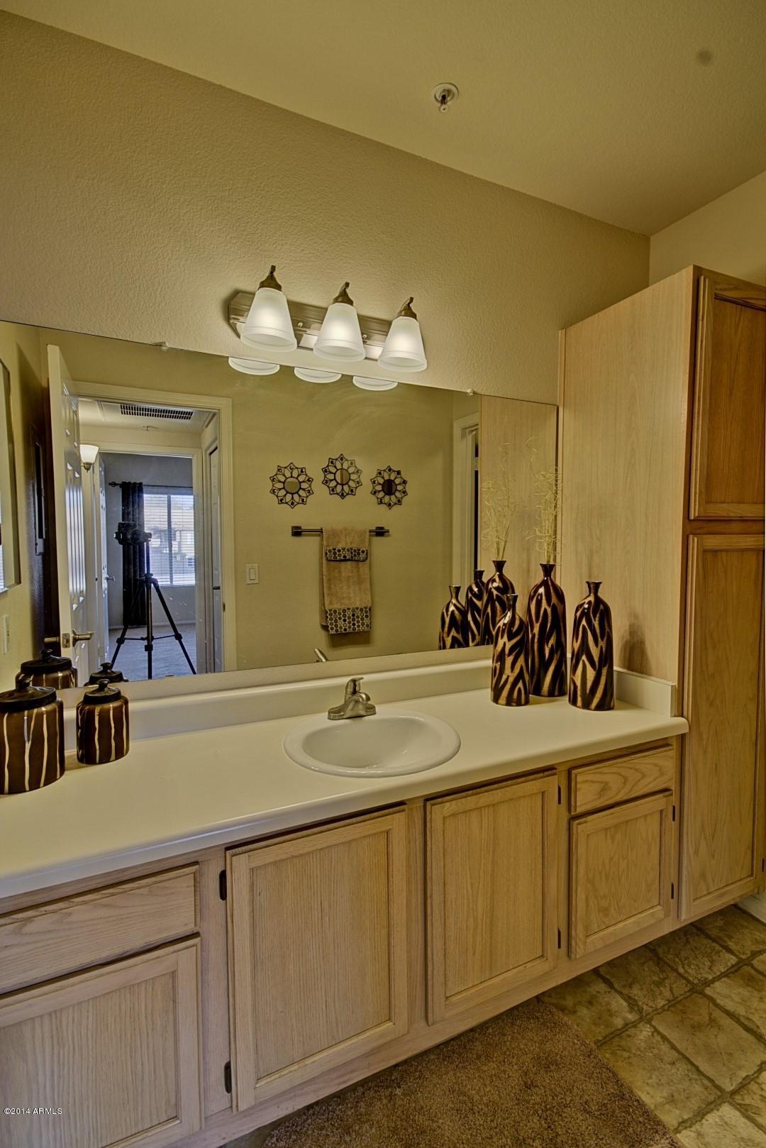 1825 West Ray Road, Unit 2055 Chandler, AZ 85224 - Photo 15 of 28 a bathroom with a sink and a mirror