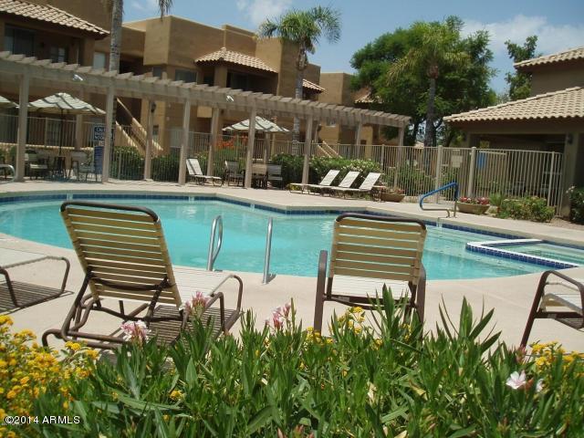 1825 West Ray Road, Unit 2055 Chandler, AZ 85224 - Photo 20 of 28 a swimming pool with outdoor seating and yard