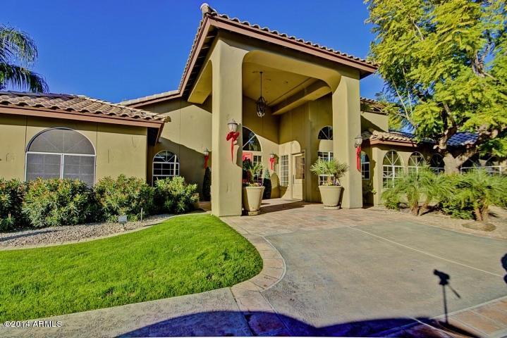1825 West Ray Road, Unit 2055 Chandler, AZ 85224 - Photo 23 of 28 a view of a white house with a big yard and potted plants