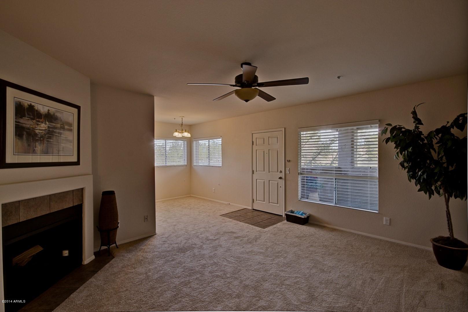 1825 West Ray Road, Unit 2055 Chandler, AZ 85224 - Photo 4 of 28 a view of empty room with windows and ceiling fan