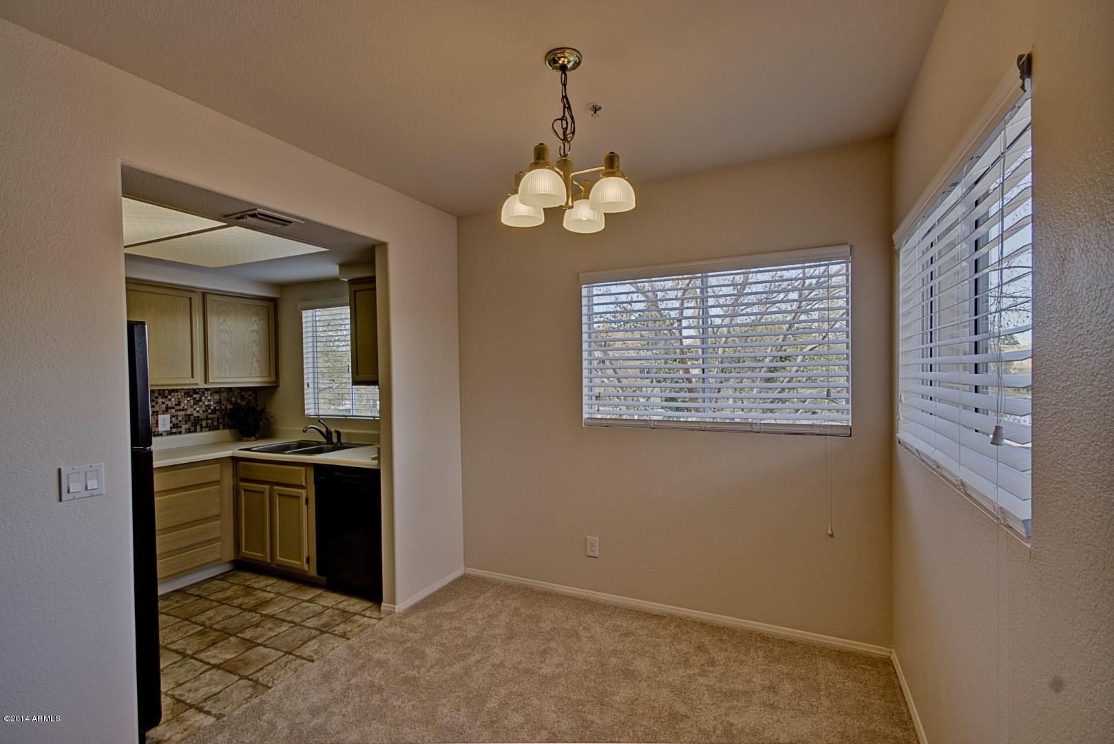 1825 West Ray Road, Unit 2055 Chandler, AZ 85224 - Photo 5 of 28 a view of a kitchen with a sink cabinets and stainless steel appliances