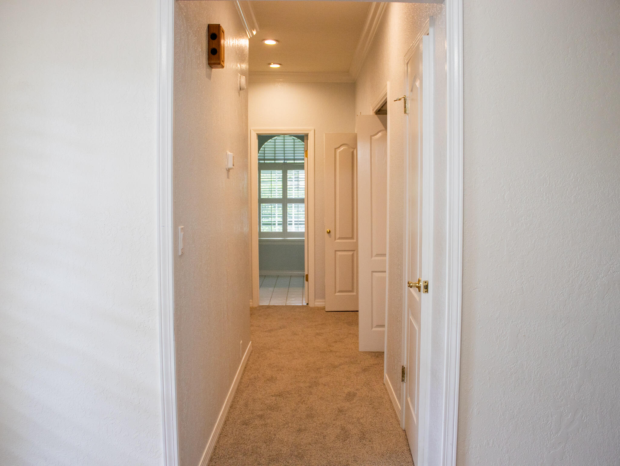 118 Baywind Drive Niceville, FL 32578 - Photo 14 of 27 a view of a hallway with wooden floor and a bathroom