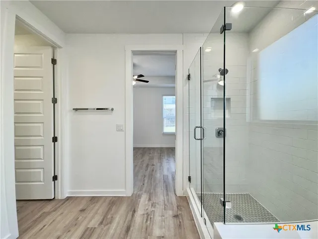a view of a hallway with wooden floor