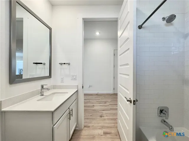 a bathroom with a sink a mirror and a bathtub