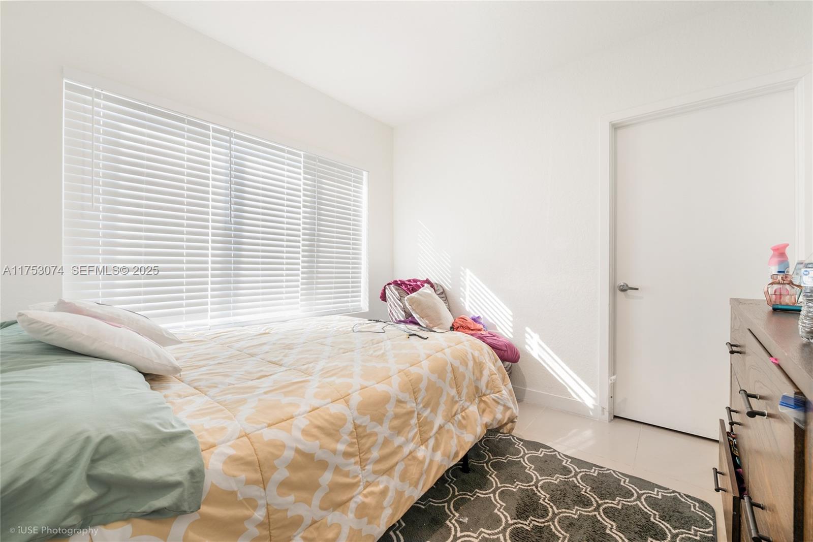 25616 Southwest 143rd Avenue Homestead, FL 33032 - Photo 11 of 12 a bedroom with a bed and a window