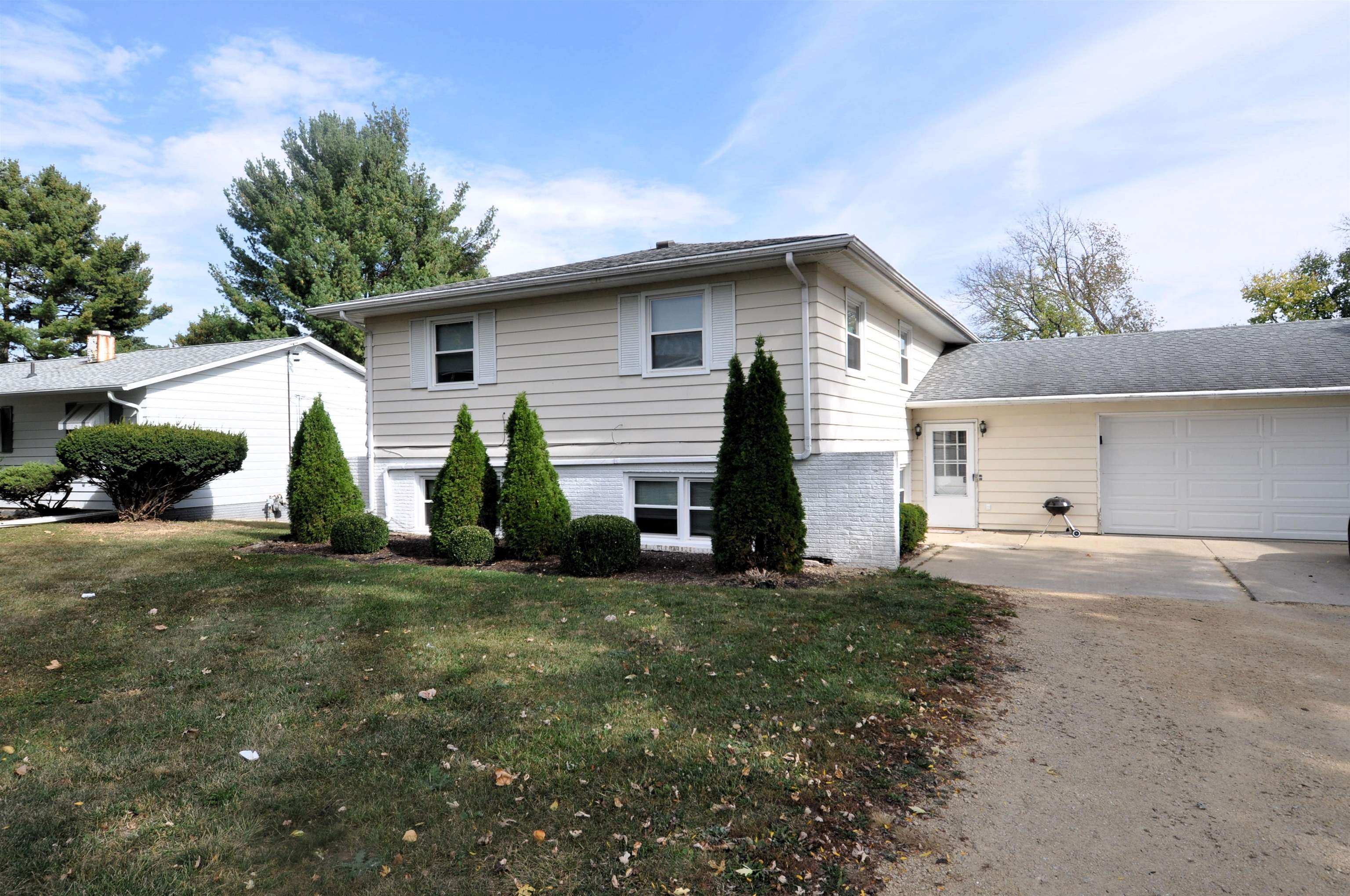 a view of a house with a yard and garage
