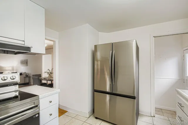 a kitchen with stainless steel appliances granite countertop a refrigerator and a stove