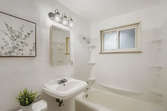 a bathroom with a sink a mirror and a bathtub