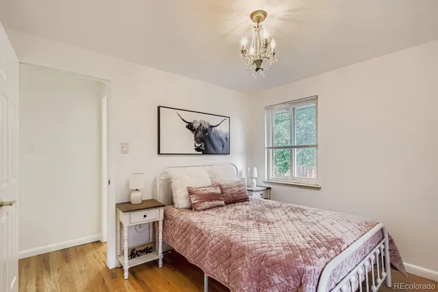 a bedroom with a bed and a chandelier