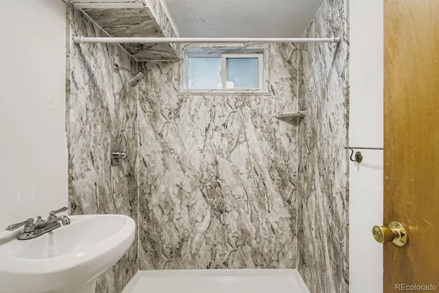 a bathroom with a sink and a shower