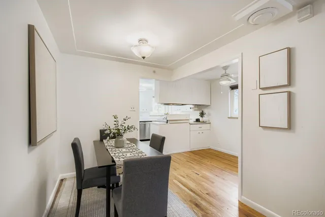 a kitchen with cabinets and chairs