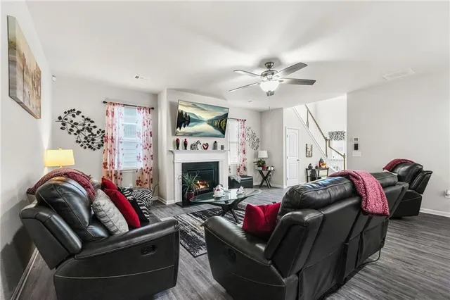 a living room with furniture fireplace and a flat screen tv
