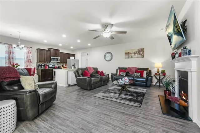 a living room with furniture a flat screen tv and a fireplace