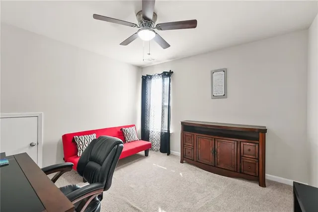a view of a livingroom with workspace and a window
