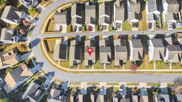 an aerial view of a house with a garden and lake view
