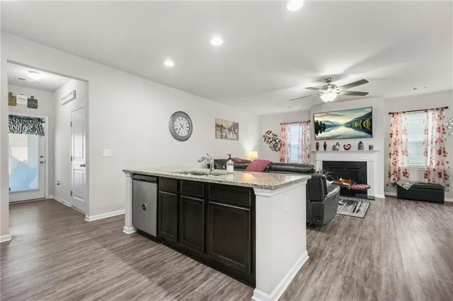 a kitchen with a sink cabinets and wooden floor