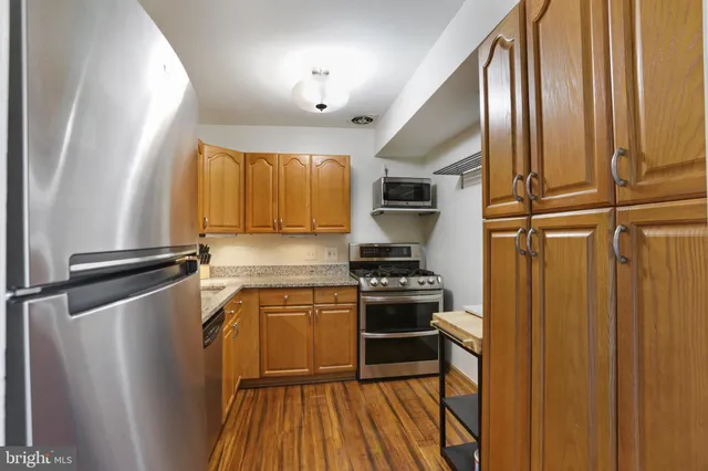 a kitchen with stainless steel appliances a sink stove and refrigerator