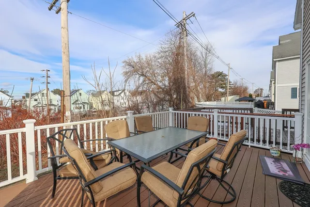 a view of a roof deck with table and chairs