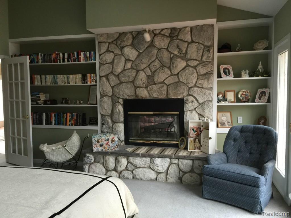 5141 Argentine Road Howell, MI 48855 - Photo 26 of 37 Master bedroom fireplace and built in book cases