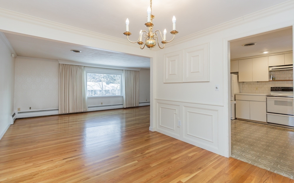 89 Jackson Drive Raynham, MA 02767 - Photo 12 of 30 a view of an empty room with a window and wooden floor
