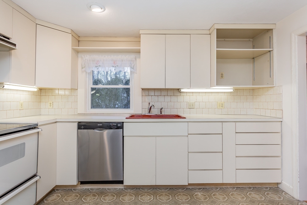 89 Jackson Drive Raynham, MA 02767 - Photo 13 of 30 a kitchen with white cabinets and sink