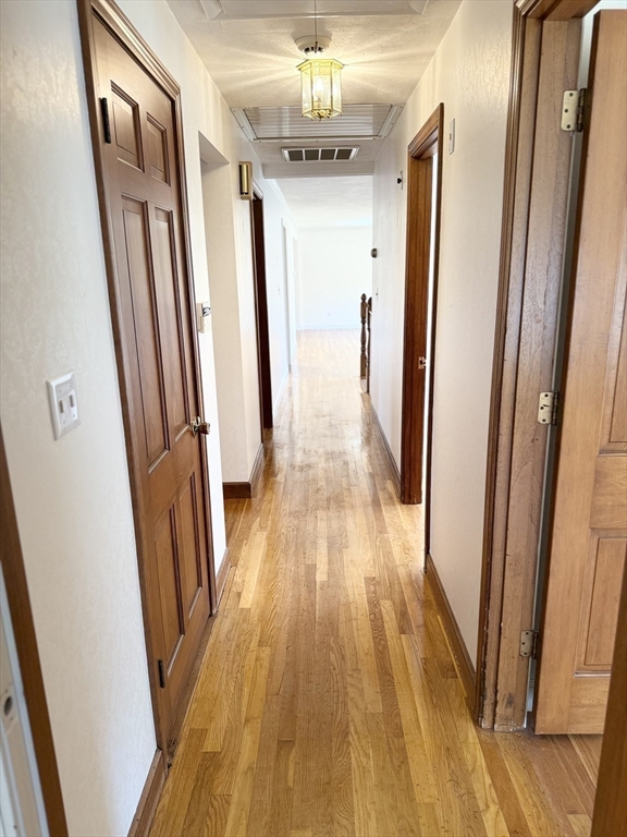 89 Jackson Drive Raynham, MA 02767 - Photo 21 of 30 a view of a hallway with wooden floor and staircase