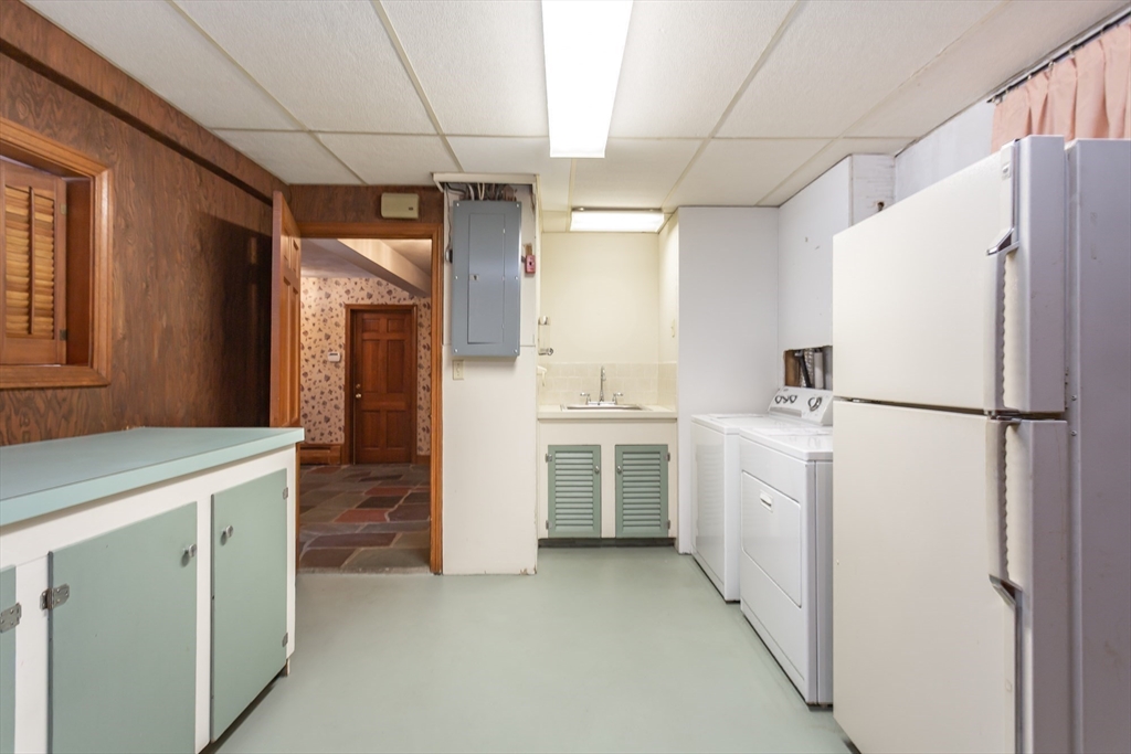 89 Jackson Drive Raynham, MA 02767 - Photo 27 of 30 a utility room with cabinets washer and dryer