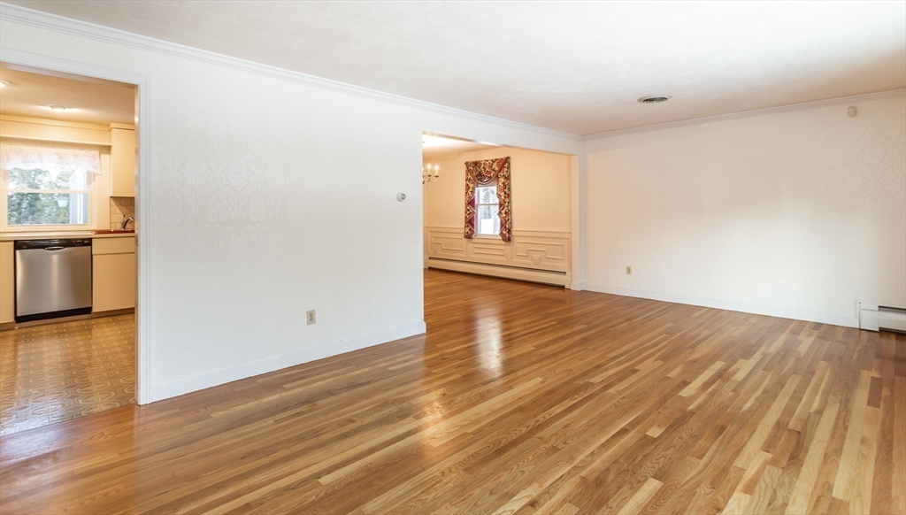 89 Jackson Drive Raynham, MA 02767 - Photo 10 of 30 an empty room with wooden floor and windows