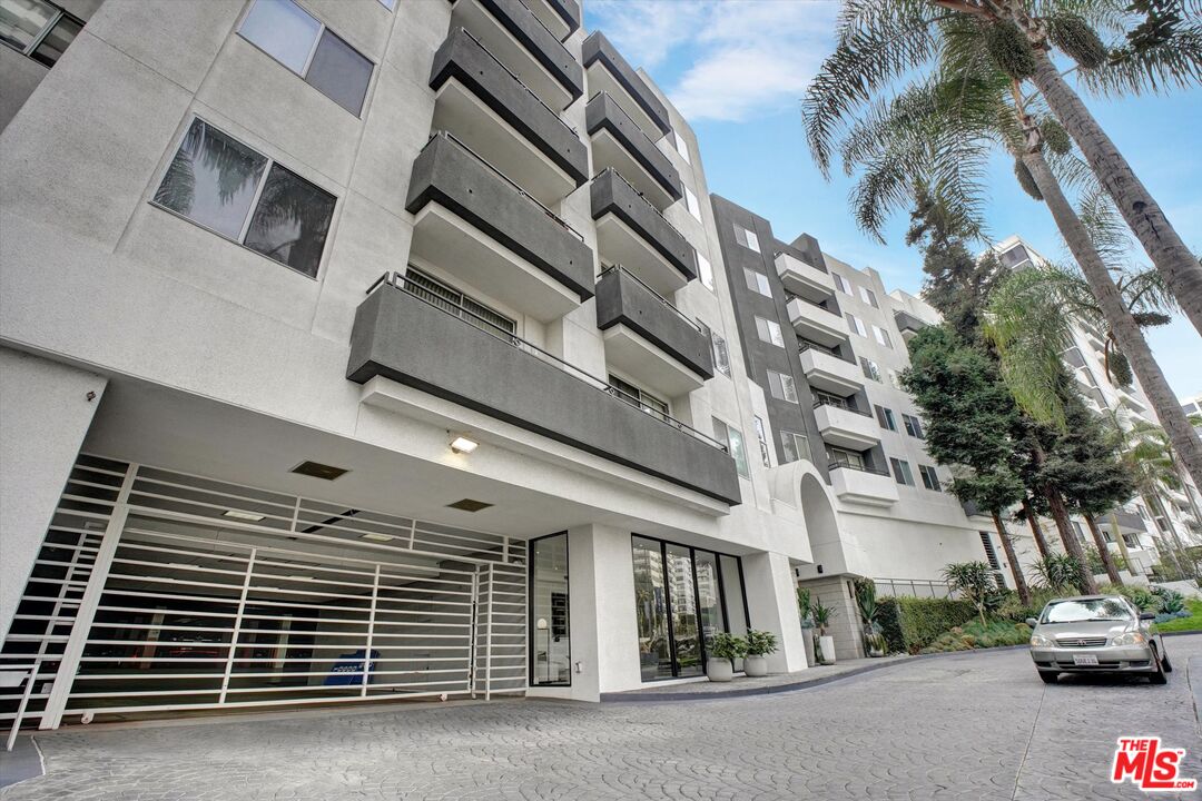 a view of building with car parked