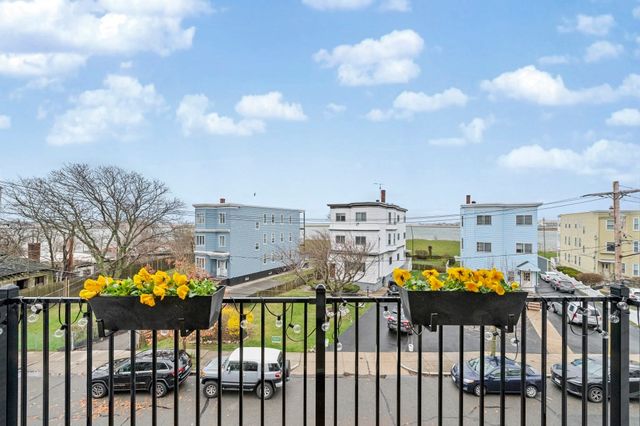 a view of a chairs and tables in the back yard of the house
