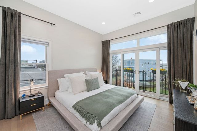 a bedroom with a large bed and a balcony view
