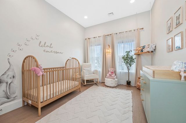 a bedroom with furniture and a large window